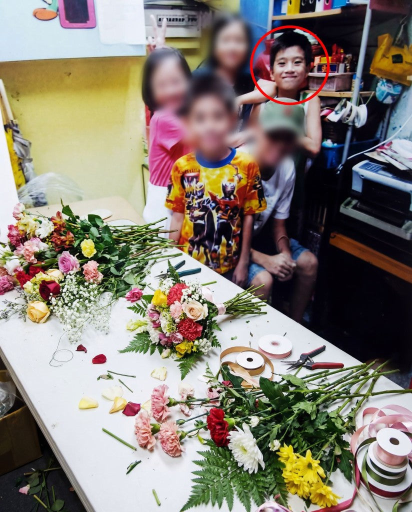 Oscar Fong as a child in the neighbourhood florist, surrounded by roses, carnations, and florist tools
